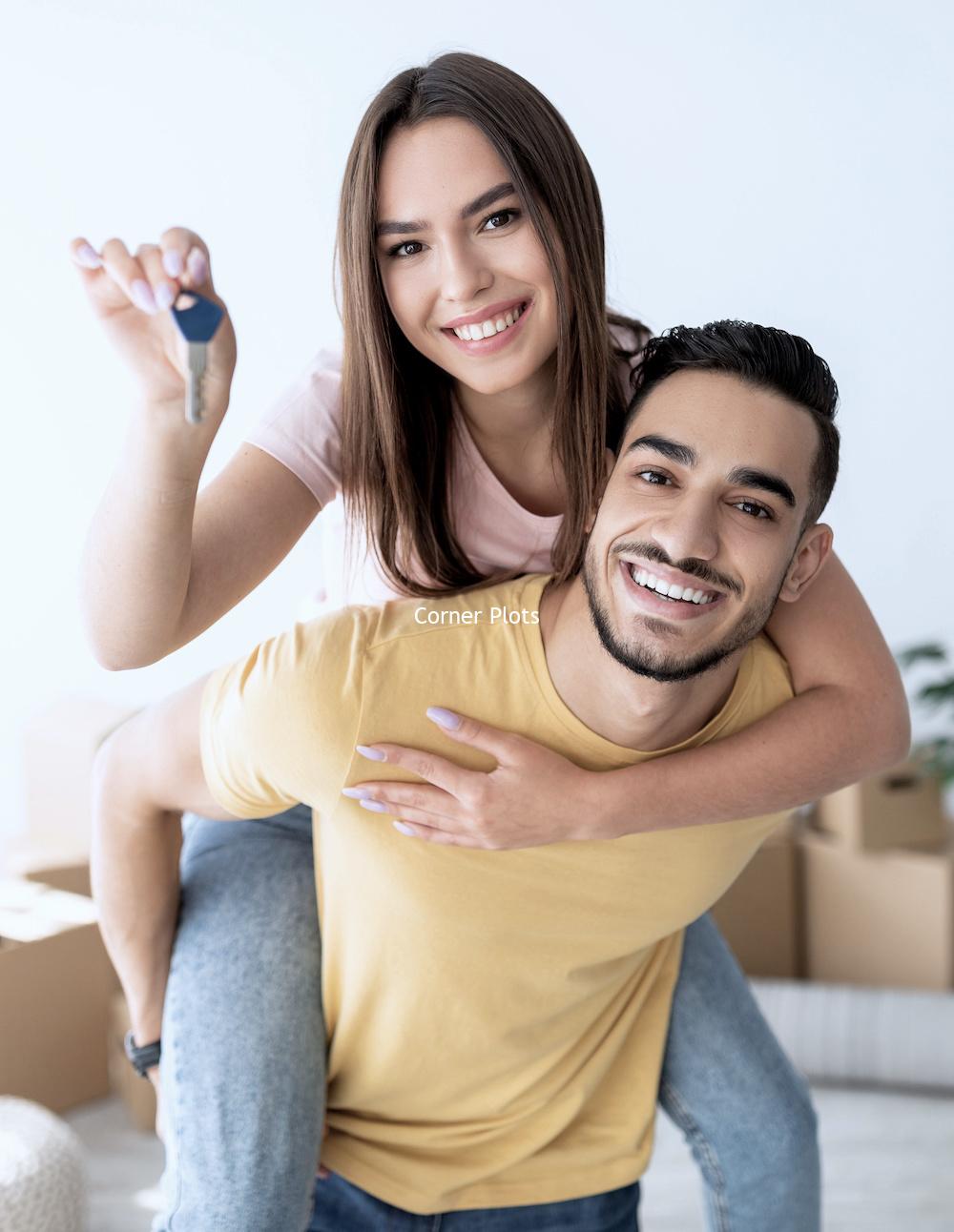 Cheerful Caucasian lady getting piggyback ride from her Arab boyfriend, showing house key indoors Cheerful Caucasian lady getting piggyback ride from her Arab boyfriend, showing house key indoors. Lovely multinational couple posing in new apartment on moving day